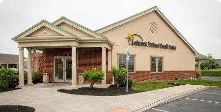 Small medical office exterior with covered entrance, brick accents, and landscaped parking lot.